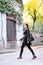 Urban young woman walking in leather jacket city