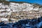 Urbanization of mountain houses on the slope of the snowy mountain in the Pyrenees, Andorra.