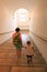 Urbino, Italy - August 9, 2017: The Castle of the Dukes of Urbino. Tourists walk along the marble staircase of the castle.