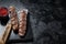 Urfa kebab, ground beef and lamb meat grilled on skewers. Black background. Top view. Copy space