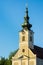 Urfahr Parish church in Linz upper Austria, view of bell tower, clock, golden sunlight, blues sky