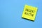 Urgent matter text on yellow sticky note