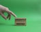 Urgently needed symbol. Concept word Urgently needed on wooden blocks. Beautiful green background. Businessman hand. Business and