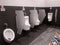 Urinal bowls are installed in men`s public toilets.