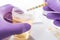 Urine test strips in purple gloves