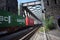 Urmitz, Germany - 08 22 2022: fast container train leaving an old bridge