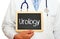 Urology - Doctor holding chalkboard with text