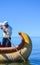 UROS FLOATING ISLANDS, PUNO, PERU. MAY 31, 2013: Unidentified native man in a traditional boat on Titicaca Lake