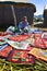 UROS FLOATING ISLANDS, PUNO, PERU. MAY 31, 2013: Unidentified native woman wearing traditional cloths, selling souvenirs