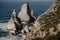 Ursa Beach Sea stack, Portugal. Atlantic Ocean Foamy waves rolling to rocks. Holiday vacation landscape scene