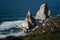 Ursa Beach Sea stack, Portugal. Atlantic Ocean Foamy waves rolling to rocks. Holiday vacation landscape scene