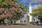 Uruguay - Colonia del Sacramento - Flowering tree of bougainvillea and old lighthouse in the historic quarter of the city