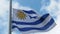 Uruguay flag fluttering in the wind. National flag against a blue sky,