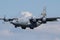 US Air Force C-130 Hercules cargo airplane in the air on final for landing