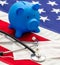 US of America health budget. Medical stethoscope, protective mask and piggy bank on a USA flag, closeup view