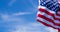 US American flag on blue sky background. For USA Memorial day, Veterans day, Labor day, or 4th of July celebration. Top view, copy