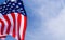 US American flag on blue sky background. For USA Memorial day, Veterans day, Labor day, or 4th of July celebration. Top view, copy