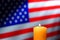 US American Flag and Commemorative Candle Burning
