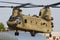 US Army Boeing CH-47 Chinook military helicopter at air base. Aviation and rotorcraft. Transport and airlift. Fly and flying