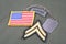 US ARMY Corporal rank patch, ranger tab, flag patch and dog tag on olive green uniform