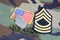 US ARMY Master Sergeant rank patch, branch tape, flag patch and dog tags on woodland camouflage unif