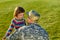 US army soldier with little daughter in park.