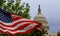 The US Capitol building with a waving American flag superimposed on the sky