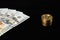 US dollar banknotes and bitcoin golden coin isolated on black background