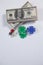 US dollars, dice and casino chips on white background