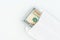 US dollars in a white envelope on a white background. The concept of income, bonuses or bribes. Corruption, salary, bonus