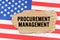 On the US flag lies a cardboard box with the inscription- PROCUREMENT MANAGEMENT