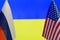 The US flag and Russian flag on the background of the Ukraine flag. Flag of USA, Russia and Ukraine. The United States of America