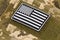 US flag sticker with textile fastener on a camouflage uniform