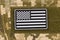 US flag sticker with textile fastener on a camouflage uniform