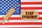 On the US flag there is a cardboard figure of a syringe and a torn cardboard with the inscription - STOP EPIDEMIC