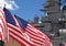 US Flags Flying Beside the Battleship Missouri Memorial, with Four Sailors