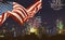 US Flags and Manhattan skyline in the night Independence day in New York City