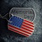 US military soldiers dog tags engraved with Memorial Day text and in the shape of the American flag