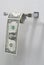 US One Dollar bills hanging in the form of roll of toilet paper