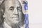 US President Franklin on a bent 100 dollar bill.