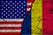 US and Romania flag on textured cracked ground. The concept of cooperation between the two countries. 3d rendering