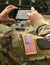 US soldier make a photo on his smartphone