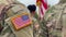 US soldiers. US army. USA patch flag on the US military uniform. Soldiers on the parade ground from the back. Veterans Day.