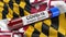 US state flag of Maryland waving in the wind with a positive Covid-19 blood test tube. 3D illustration concept.
