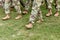 US troops. Soldiers marching on green grass. US Army