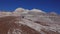 USA,  Arizona - November 17, 2019: The Painted Desert on a sunny day. Photographer on a background of multi-colored clay mountains