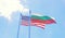 USA and Bulgaria flags waving against blue sky.