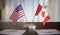USA and Canada flags on table. Negotiation and partnership concept. 3D rendered illustration.
