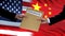 USA and China officials exchanging confidential envelope, flags background