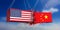 USA and China trade war. US of America and chinese flags crashed containers on blue sky background.